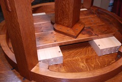 Detail maple table glides viewed from below.